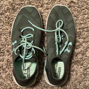 Green and blue under armor running shoes